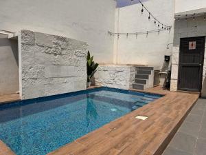 a large swimming pool with blue water in a building at Casa Tulipán in Monterrey +2 photos