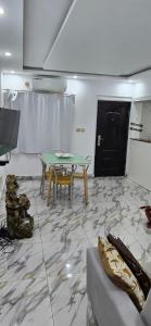 a living room with a table and a couch at Immobilier Du siecle in Abidjan