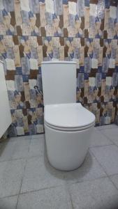 a white toilet sitting in front of a wall at Immobilier Du siecle in Abidjan