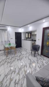 a living room with a table and a dining room at Immobilier Du siecle in Abidjan +8 photos