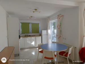 a kitchen with a table and chairs in a room at Casa Albinelor - Apartament 2-6 persoane in Braşov +38 photos