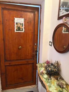 a door in a room with a table and a mirror at Del Rio Palace Guest House in Certaldo