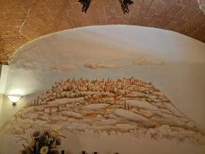 a painting on the wall of a room with a wall at Del Rio Palace Guest House in Certaldo