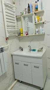 a white bathroom with a sink and a mirror at Bilalguesthouse in Dzhangyaryk +21 photos
