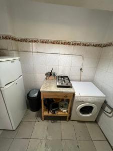 a small kitchen with a stove and a refrigerator at Lafayette Apartment in Tunis