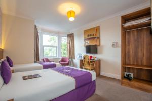 a hotel room with a bed and a table at Revado Hotel, Norwich City Centre in Norwich