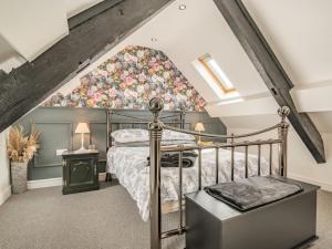 a bedroom with a bed with a floral headboard at 3 Bed in Brecon oc-92320 in Llandeilor-Fan