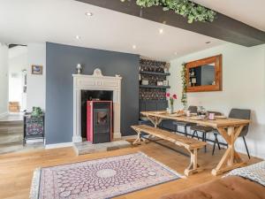 a living room with a table and a fireplace at 3 Bed in Brecon oc-92320 in Llandeilor-Fan +24 photos