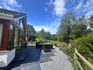 a patio with a bench and a table and a view at 4 Bed in Llanidloes oc-95968 in Van