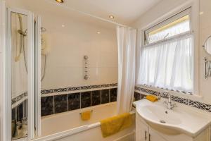a bathroom with a tub and a sink and a shower at 3 Bed in Brecon oc-bn363 in Brecon +37 photos