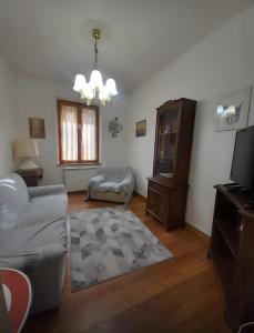 a living room with a couch and a tv at La Cascinassa in Tagliolo Monferrato