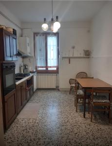 a kitchen with a table and a dining room at La Cascinassa in Tagliolo Monferrato