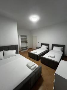a room with two beds and a room with at Hotel Gjakova-Shëngjin in Shëngjin