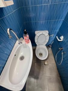 a bathroom with a white toilet and a sink at Lafayette Apartment in Tunis +5 photos