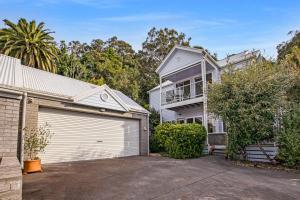 a large white house with a garage at Bliss by the Bay in Metung