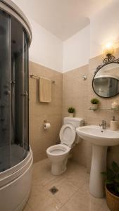 a bathroom with a toilet and a sink and a shower at Belli Siciliani Bed&Breakfast in Bucharest