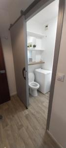 a bathroom with a white toilet in a room at Studio Beauséjour in Niort +10 photos