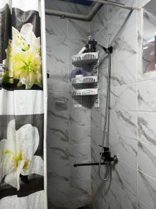 a shower in a bathroom with white marble at Jumgal Nomad Nest in Kyzart +10 photos