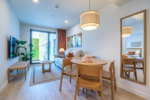 a dining room and living room with a table and chairs at Aduana Suites in Salou