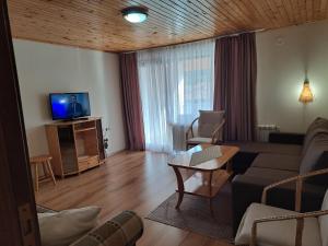 a living room with a couch and a tv at Guest House Benita in Devin