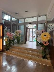 a lobby with vases of flowers in a building at Kolejarz Natura Tour in Zakopane