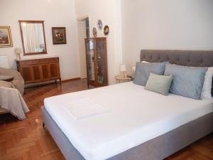 a bedroom with a large white bed in a room at Central Family Flat Volos in Volos +13 photos