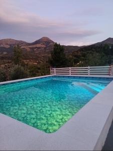 a swimming pool with a view of the mountains at Los Cabales in Torres