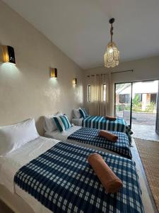 a bedroom with two beds and a couch at Kaouki paradise tafoukt in Essaouira