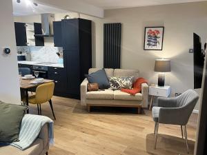 a living room with a couch and a table at Melton House in Houghton Regis