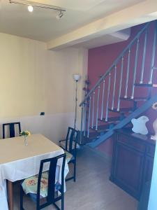 a dining room with a table and a staircase at B&b DA FELICE MONOLOCALE in Serino
