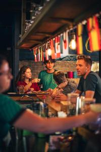 a group of people sitting at a bar at Viajero San José Hostel in San José