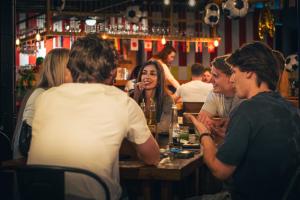 a group of people sitting at a bar at Viajero San José Hostel in San José