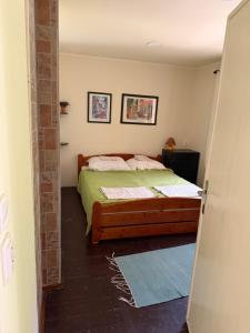 a bedroom with a bed with a green comforter at Chata Dorka in Kamenica nad Hronom