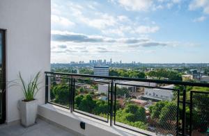 a balcony with a view of a city at Peaceful Stay with Rooftop Pool Access in Fernando de la Mora