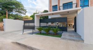 a house with a balcony with plants in front of it at Peaceful Stay with Rooftop Pool Access in Fernando de la Mora +13 photos