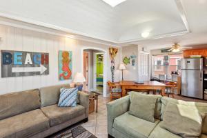 a living room with a couch and a table at 5065 - Flip Flop Inn in Kill Devil Hills
