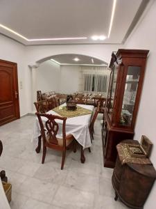 a dining room with a table and a mirror at California Stay in Amman +6 photos