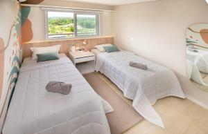 a bedroom with two beds and a window at 3BR Apartment Pool & Garage Sleeps 6 in San Bernardino
