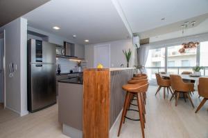 a kitchen with a counter and a table with chairs at 3BR Apartment Pool & Garage Sleeps 6 in San Bernardino