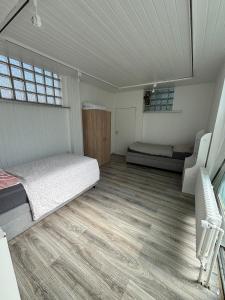 a bedroom with a bed and a couch in a room at Loft character in Eggenstein-Leopoldshafen