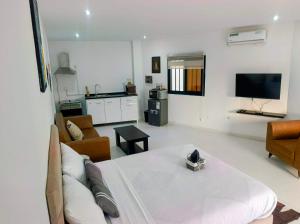 a living room with a couch and a tv at Izuba in Ngaparou