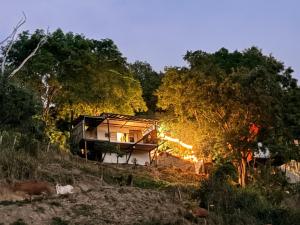 a house sitting on top of a hill with trees at cabaña emanuel in Sopetrán