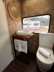 a bathroom with a sink and a toilet and a mirror at Roulotte Beach São Tomé in Triunfo +14 photos