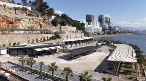 a view of a beach with palm trees and buildings at Hotel Brigeni & Camping Riviera in Shëngjin