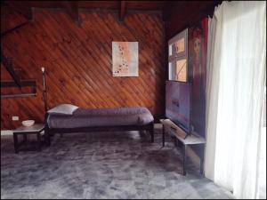 a room with a bed and a tv in it at Lo de Adriana in Tandil +6 photos