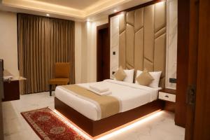 a bedroom with a large bed in a room at The Vatika Paradise in Ayodhya +15 photos