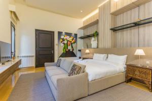 a large bedroom with a bed and a couch at Convivium 5 - High-end Studio in Gemmayze in Beirut