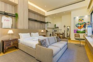 a hotel room with a bed and a couch at Convivium 5 - High-end Studio in Gemmayze in Beirut