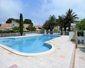 a large swimming pool in a yard with trees at Coul in Valras-Plage