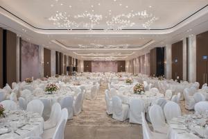 a banquet hall with white tables and white chairs at Adams Beach Hotel & Spa in Ayia Napa +90 photos